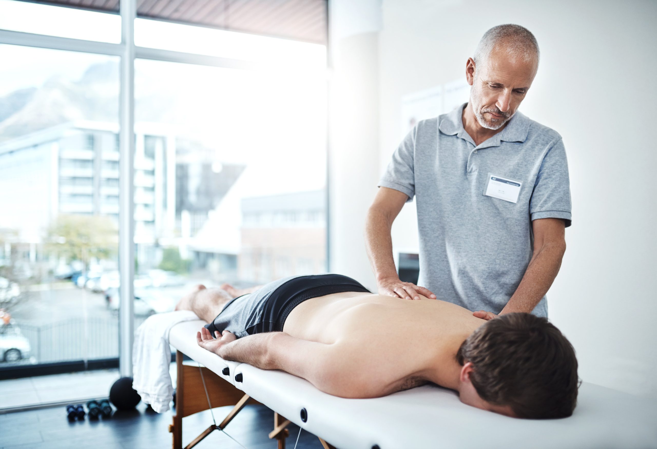 man-muscle-pain-physiotherapist-consulting-working-rehabilitation-with-exercise-wellness-male-people-office-together-physiotherapy-service-with-health-insurance-back-support